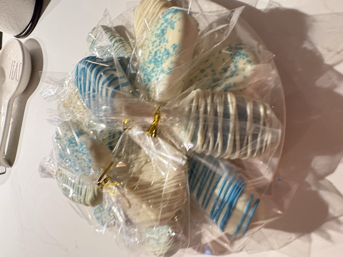 An assortment of wrapped blue and white cake pops